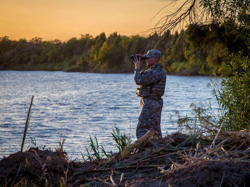 A member of the Texas National Guard observes the Rio Grande River